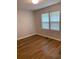 Cozy bedroom with natural light from two windows and stylish wood-look flooring at 2467 Shady Grove Rd, Carrollton, GA 30116