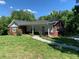 Charming bungalow with brick accents and a walkway leading to the front door, nestled in a lush, green yard at 2467 Shady Grove Rd, Carrollton, GA 30116