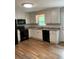 Modern kitchen featuring white cabinets, black appliances, and a stylish countertop at 2467 Shady Grove Rd, Carrollton, GA 30116