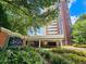 City Heights Condominiums exterior view featuring lush landscaping and a grand entrance, offering a serene welcome at 375 Ralph Mcgill Blvd # 603, Atlanta, GA 30312