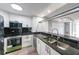 Modern kitchen with stainless steel appliances, granite countertops, and sleek black backsplash at 375 Ralph Mcgill Blvd # 603, Atlanta, GA 30312