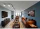 Staged living room featuring modern lighting, a stylish leather sofa, and a mounted TV at 375 Ralph Mcgill Blvd # 603, Atlanta, GA 30312