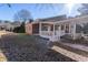 Exterior back view featuring a screened-in porch and charming covered deck at 341 Little John Nw Dr, Lilburn, GA 30047