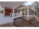 View of covered porch, a brick exterior wall, and a sunroom at 341 Little John Nw Dr, Lilburn, GA 30047