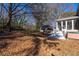 Large backyard with wooded border, screened porch, and outbuilding providing space for outdoor living at 341 Little John Nw Dr, Lilburn, GA 30047