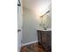 Bathroom featuring a dark wood vanity, modern fixtures, and unique herringbone-patterned flooring at 341 Little John Nw Dr, Lilburn, GA 30047