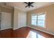 Bright bedroom features hardwood floors, large window, ceiling fan, and closet at 341 Little John Nw Dr, Lilburn, GA 30047