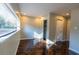 Bedroom with herringbone floors, bright natural light, and closet with mirrored doors at 341 Little John Nw Dr, Lilburn, GA 30047