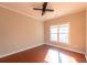 Bright bedroom features hardwood floors, a large window, and a ceiling fan at 341 Little John Nw Dr, Lilburn, GA 30047