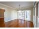 Elegant dining area with hardwood floors, stylish lighting, and a door leading to the porch at 341 Little John Nw Dr, Lilburn, GA 30047