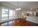 A bright dining room with hardwood floors and a view into the kitchen at 341 Little John Nw Dr, Lilburn, GA 30047