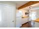 Bright kitchen with white appliances, wood countertops, and herringbone floors at 341 Little John Nw Dr, Lilburn, GA 30047