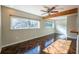 Sunny living room with wooden beam, herringbone-patterned floors, and large windows for natural light at 341 Little John Nw Dr, Lilburn, GA 30047