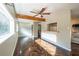 Open living area with herringbone floors and wood ceiling beam at 341 Little John Nw Dr, Lilburn, GA 30047