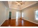 A spacious main bedroom with tray ceilings and hardwood floors at 341 Little John Nw Dr, Lilburn, GA 30047