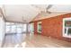 Inviting sunroom featuring brick accent wall, tile floors, and multiple windows at 341 Little John Nw Dr, Lilburn, GA 30047