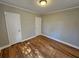 Hardwood floor bedroom with neutral walls and ceiling light at 1877 Lomita Rd, Atlanta, GA 30316