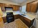 Modern kitchen featuring dark wood cabinets and quartz countertops at 1877 Lomita Rd, Atlanta, GA 30316