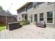 A back deck with a woven sofa and a house with gray siding and large windows are featured in the image at 243 Yorkshire Ln, Villa Rica, GA 30180