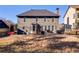 The home's back facade showcases neutral siding and a spacious backyard, ideal for outdoor enjoyment at 243 Yorkshire Ln, Villa Rica, GA 30180