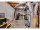 Unfinished basement showcasing exposed utilities, a work area, and ample storage space at 243 Yorkshire Ln, Villa Rica, GA 30180