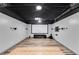 Finished basement featuring wood-look flooring, entertainment area, projector, and speakers at 243 Yorkshire Ln, Villa Rica, GA 30180