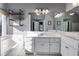 Elegant bathroom featuring dual sinks, a soaking tub, and a large mirror with modern lighting at 243 Yorkshire Ln, Villa Rica, GA 30180