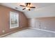 This cozy bedroom has carpet, neutral walls, attic access, and lots of natural light at 243 Yorkshire Ln, Villa Rica, GA 30180