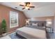 A staged bedroom featuring a queen bed, neutral colors, and natural light from the window at 243 Yorkshire Ln, Villa Rica, GA 30180
