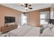 Cozy bedroom featuring a ceiling fan, plush bed, and large windows for natural light at 243 Yorkshire Ln, Villa Rica, GA 30180