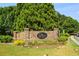 Stone community entrance sign surrounded by lush landscaping and greenery at 243 Yorkshire Ln, Villa Rica, GA 30180
