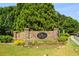 Stone community entrance with lush landscaping and colorful flowers welcomes residents and visitors alike at 243 Yorkshire Ln, Villa Rica, GA 30180