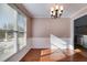 Dining room featuring hardwood floors, wainscoting, and a stylish chandelier at 243 Yorkshire Ln, Villa Rica, GA 30180
