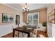Staged dining room featuring hardwood floors, modern chandelier, bright window and neutral color palette at 243 Yorkshire Ln, Villa Rica, GA 30180