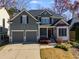 Two-story house with gray siding, two-car garage, and landscaping at 243 Yorkshire Ln, Villa Rica, GA 30180