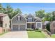 Charming home featuring a well-manicured lawn, stone accents, and a two-car garage at 243 Yorkshire Ln, Villa Rica, GA 30180