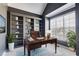 Stylish home office featuring built-in bookshelves, large windows, and ample natural light at 243 Yorkshire Ln, Villa Rica, GA 30180