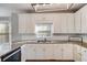 Bright kitchen featuring white cabinets, stainless steel appliances, and stone countertops for a modern aesthetic at 243 Yorkshire Ln, Villa Rica, GA 30180