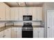 Modern kitchen featuring granite countertops and white cabinetry, complete with stainless steel appliances at 243 Yorkshire Ln, Villa Rica, GA 30180