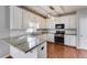 Updated kitchen features modern stainless appliances, light cabinets, and granite countertops at 243 Yorkshire Ln, Villa Rica, GA 30180
