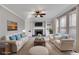 Staged living room featuring a stone fireplace, built-in bookshelves, neutral tones, and comfortable seating at 243 Yorkshire Ln, Villa Rica, GA 30180