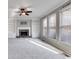 Bright living room with fireplace, built-in shelves and large windows providing ample sunlight at 243 Yorkshire Ln, Villa Rica, GA 30180