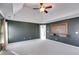 Spacious main bedroom featuring plush carpeting, tray ceiling, and built-in media center at 243 Yorkshire Ln, Villa Rica, GA 30180