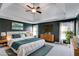 This main bedroom features a tray ceiling, a ceiling fan, and a large bed with stylish decor at 243 Yorkshire Ln, Villa Rica, GA 30180