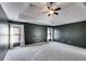 Bright main bedroom showing a tray ceiling, carpeted floor, and large windows with white curtains at 243 Yorkshire Ln, Villa Rica, GA 30180