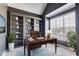 Home office featuring built-in bookshelves, a large window, and a wooden desk at 243 Yorkshire Ln, Villa Rica, GA 30180