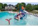 Community pool with water features, slides, and plenty of lounge seating surrounding it at 243 Yorkshire Ln, Villa Rica, GA 30180