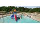 Community pool area with a splash pad and lounge chairs at 243 Yorkshire Ln, Villa Rica, GA 30180