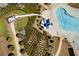 Aerial shot of the community pool area, featuring lush landscaping, a winding slide, and comfortable lounge chairs at 243 Yorkshire Ln, Villa Rica, GA 30180