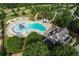 Aerial view showcasing a community pool area with multiple pools, slides, and nearby clubhouse at 243 Yorkshire Ln, Villa Rica, GA 30180